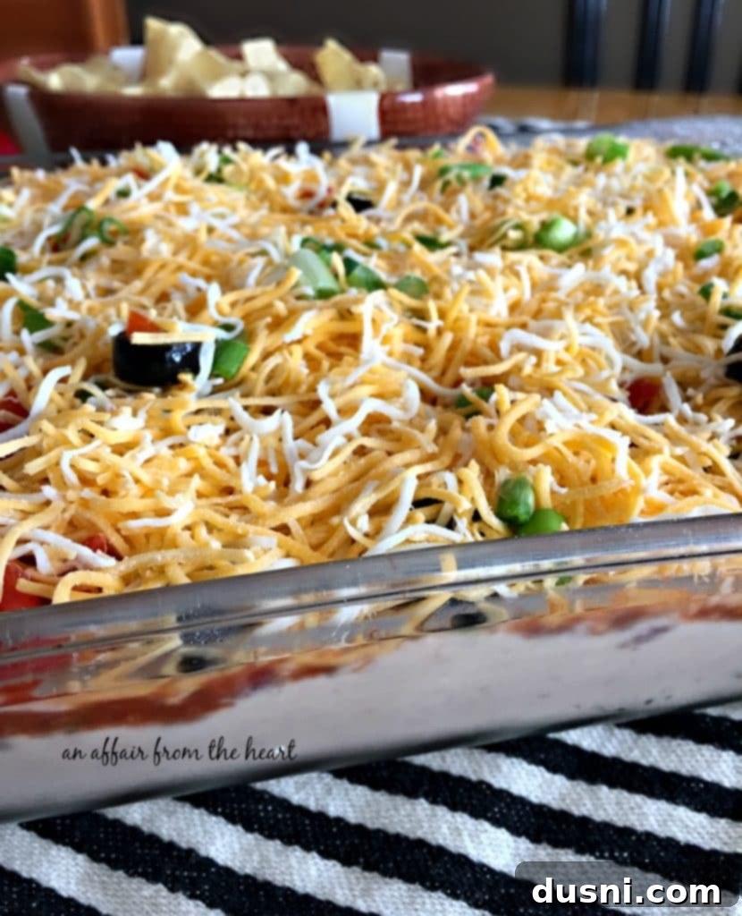 Close-up of the delicious layers in Mexican Layered Bean Dip, ready to be scooped