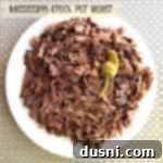 Mississippi Crock Pot Roast on a white plate with gravy