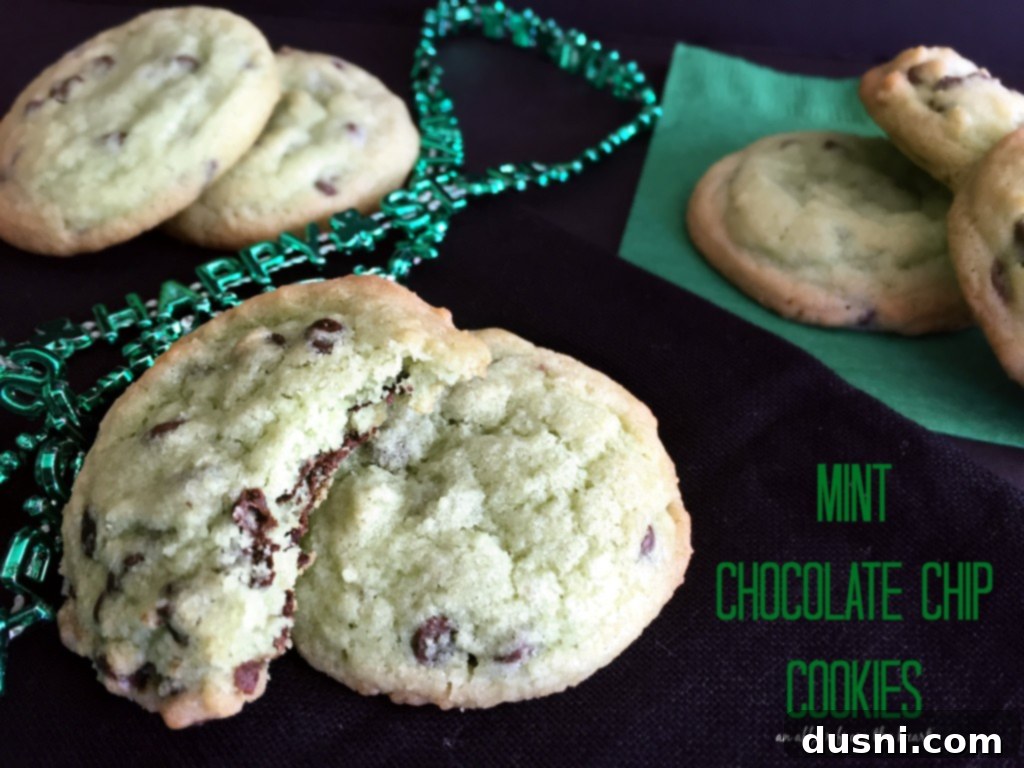 Vibrant Green Mint Chocolate Chip Cookies scattered on a white plate