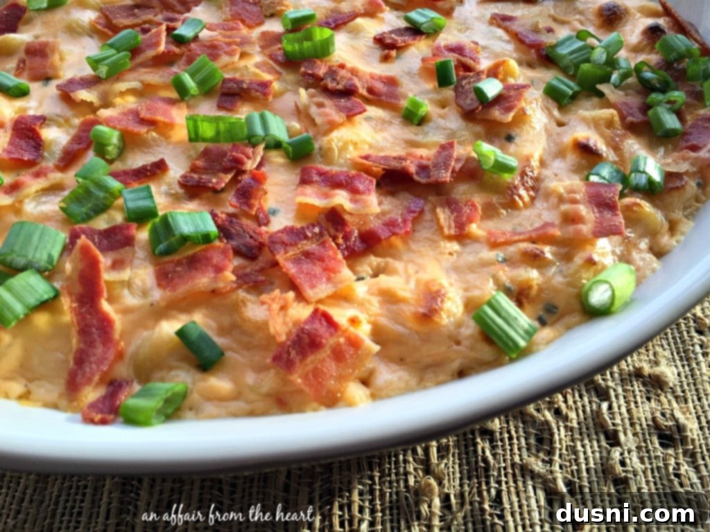 Deliciously Creamy Loaded Mac 'n Cheese garnished with bacon and green onions, ready to serve