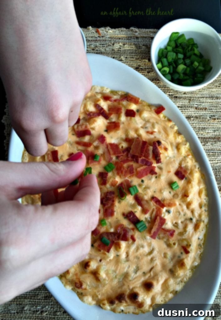 Freshly baked Loaded Mac 'n Cheese bubbling hot in a casserole dish, prior to adding final toppings