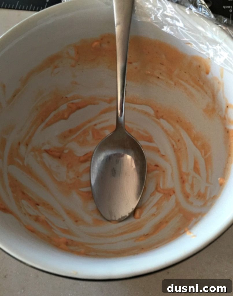 Whip Up Your Own Thousand Island Dressing 4 A close-up view of a small, inviting bowl of 1000 Island Dressing, showcasing its creamy texture.