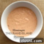 Whip Up Your Own Thousand Island Dressing 6 overhead of dressing in a white bowl with text 'Homemade Thousand Island Dressing'