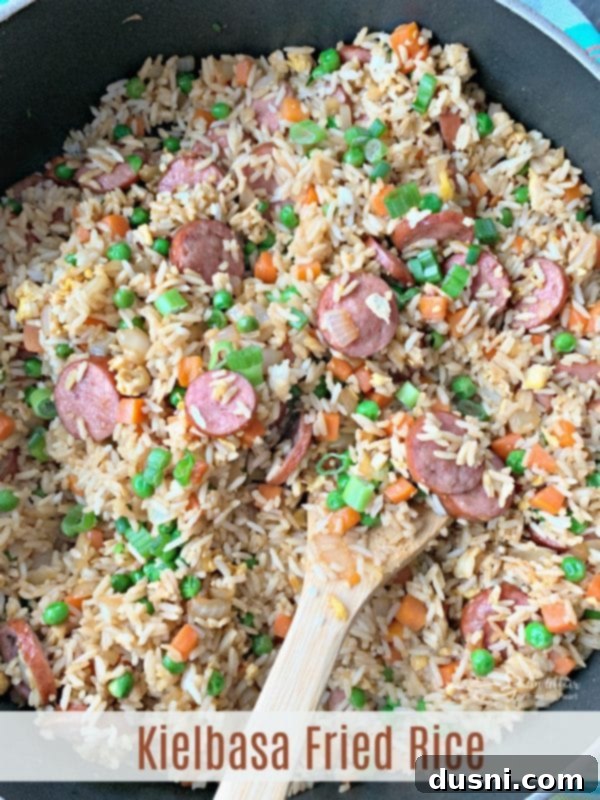 Hearty Kielbasa Fried Rice 18 Kielbasa Fried Rice served in a skillet, with a side plate, ready for a meal