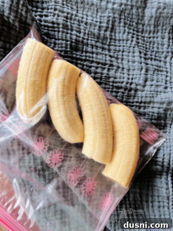 Three whole peeled bananas, perfectly ripe and ready to be frozen.