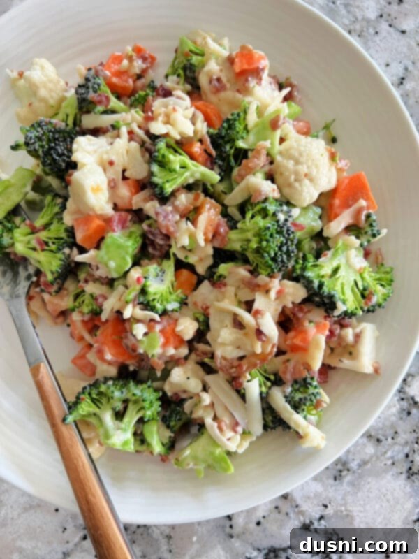 Vibrant Italian Garden Salad 2 A large bowl of Italian Raw Veggie Salad with cauliflower, broccoli, carrots, mozzarella, and bacon, ready to serve.