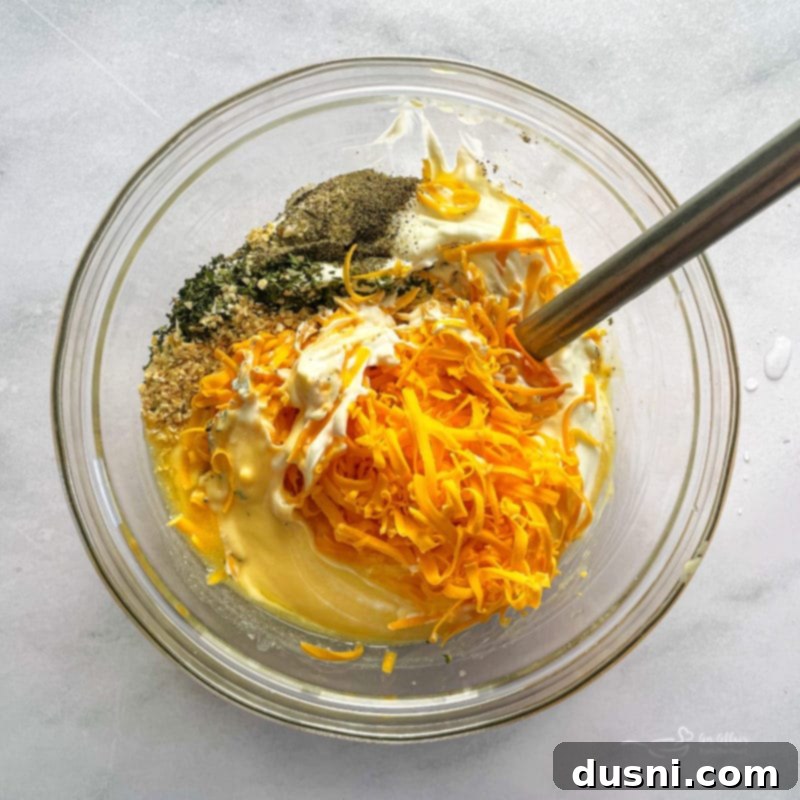 Golden Cheesy Hash Brown Bake 6 Combined soup, sour cream, 1/4 cup of melted butter, 1 1/2 cups cheese, onion pepper and parsley - into a smooth mixture