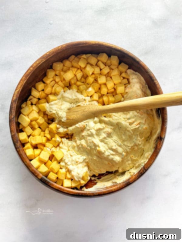 Golden Cheesy Hash Brown Bake 7 Pour into prepared baking dish. - evenly spreading the hash brown mixture