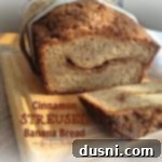 Cinnamon Streusel banana bread on a wood cutting board with the end cut off. Text "Cinnamon streusel banana bread"