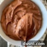 Ultimate Sour Cream Chocolate Frosting 11 Close up of Sour Cream Chocolate Frosting on a spoon