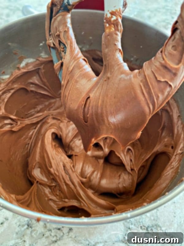 Ultimate Sour Cream Chocolate Frosting 6 Mixing bowl with sour cream chocolate frosting and a beater
