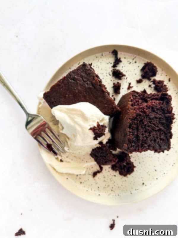 Simple Comfort Bake 2 A slice of Depression Cake on a white plate with a fork.
