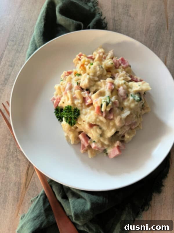 Serving of Chicken Cordon Bleu Casserole with Rice on a plate, showing the creamy texture