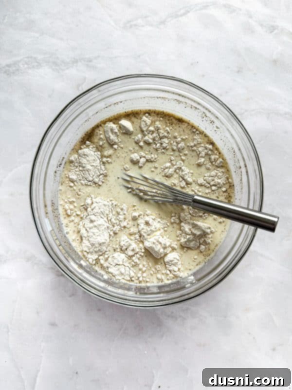 Creamy Chicken and Mushroom Florentine Pasta 12 Mushrooms and minced garlic sautéing in butter in a skillet.