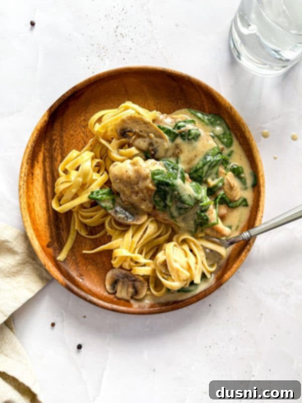Creamy Chicken and Mushroom Florentine Pasta 3 Overhead shot of creamy Chicken Mushroom Florentine Pasta in a large skillet, ready to be served.