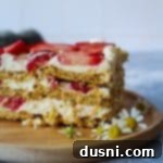 Close up of a slice of Old fashioned Strawberry icebox cake on a wood plate.