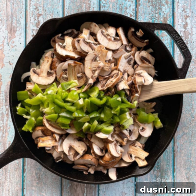 Loaded Philly Cheese Steak Peppers 10 mushrooms and peppers in a pan