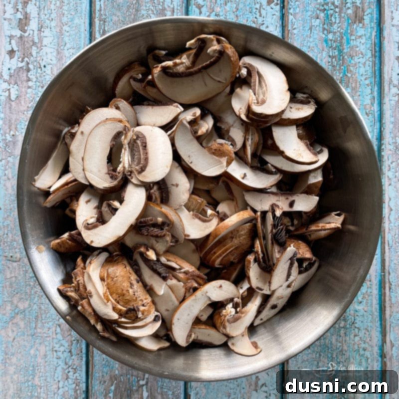 Loaded Philly Cheese Steak Peppers 7 sliced mushrooms in a bowl