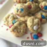 Star-Spangled M&M Pudding Cookies 7 Cookies on a white plate with text "Patriotic M&M Pudding Cookies"