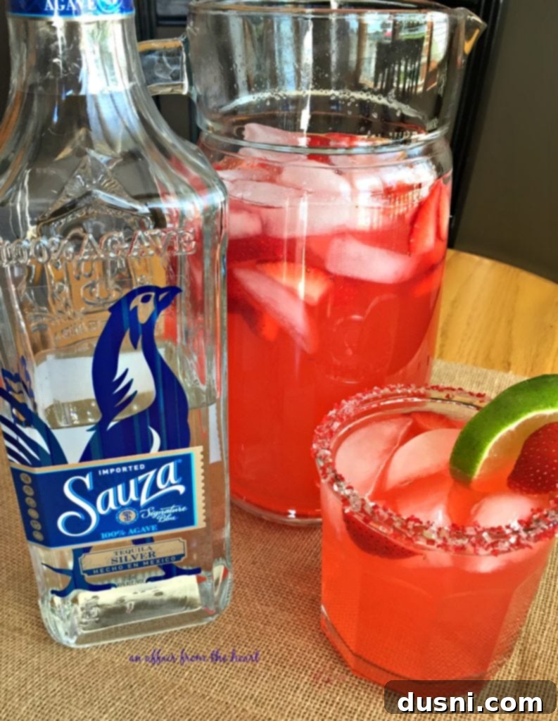 Summertime Strawberry Margaritas 4 Sauza Strawberry Margaritas pitcher and glasses with garnishes