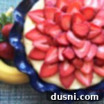 Extreme close up of Strawberry Banana Cream Pie, highlighting the texture of the fruit and cream.