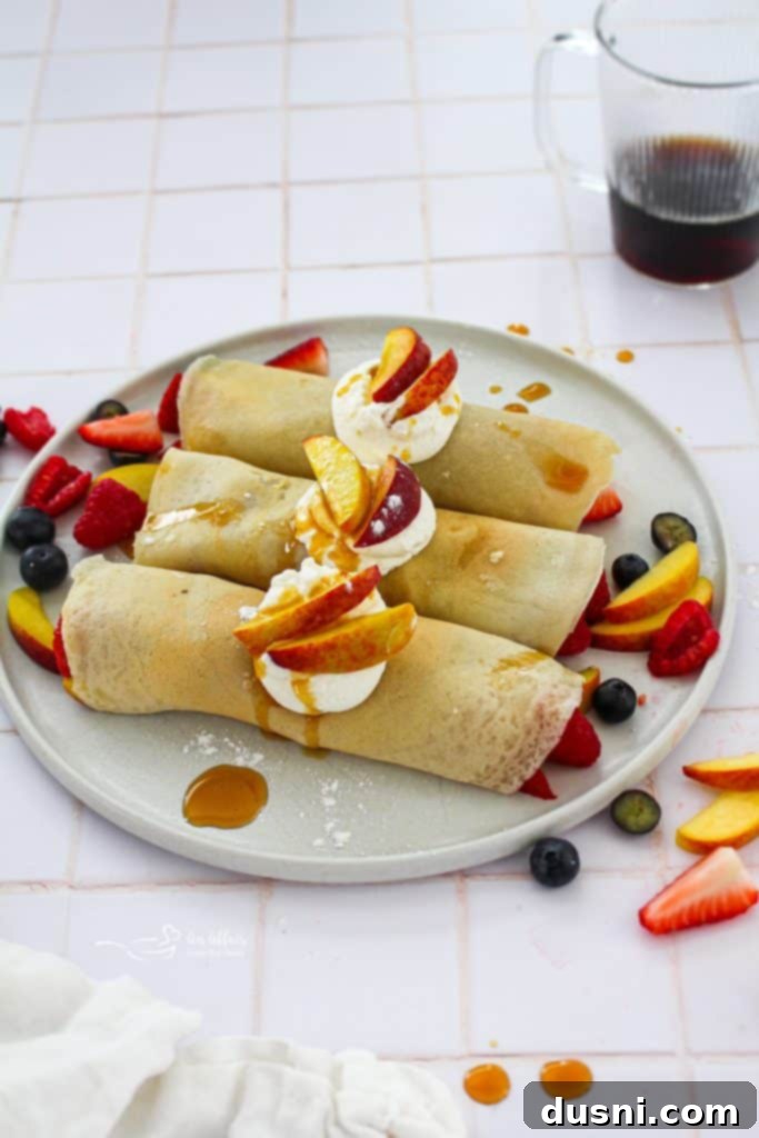 Golden Crepes Topped with Summer Fruits 3 Delicate Sweet Crepes filled with berries and peaches