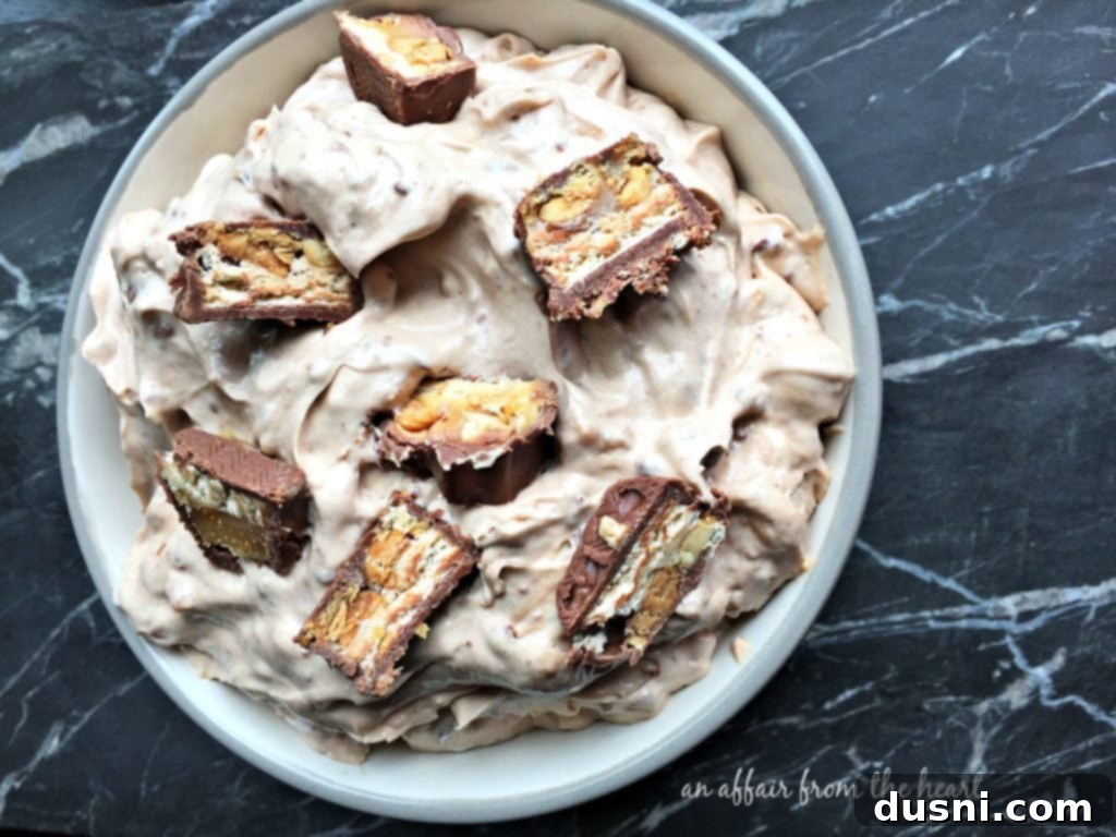 Decadent Snickers Dip 9 Another perspective of the delicious Snickers Dip in a serving bowl.