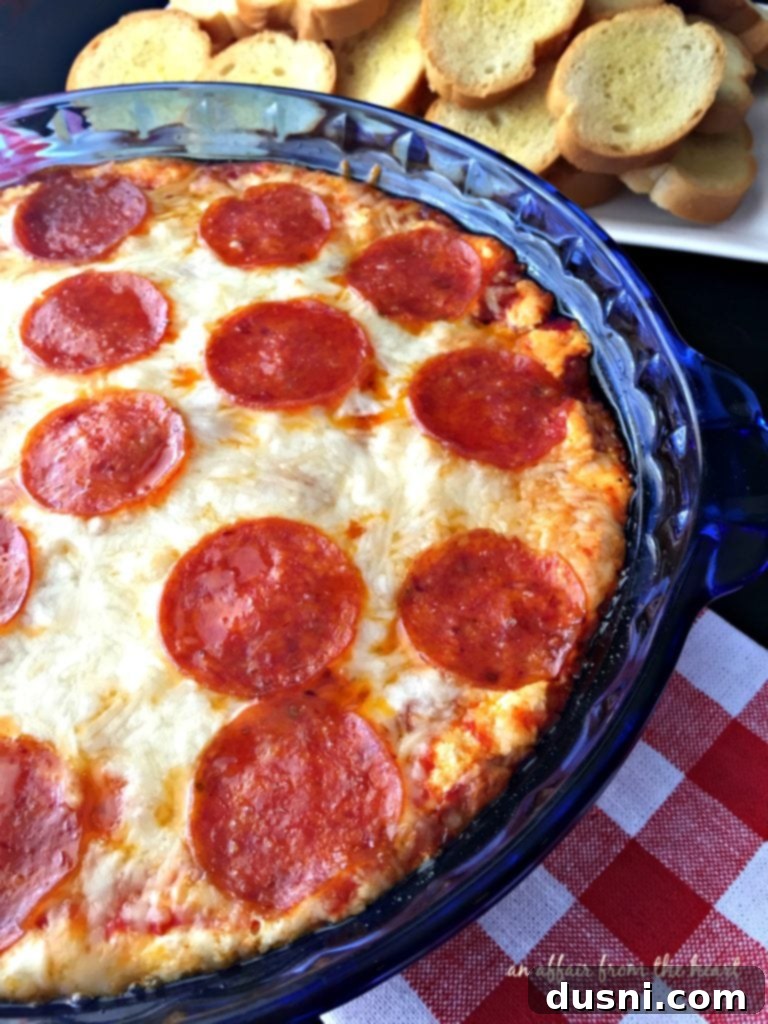 Freshly baked Pizza Dip, hot and ready to eat, served with golden garlic bread slices