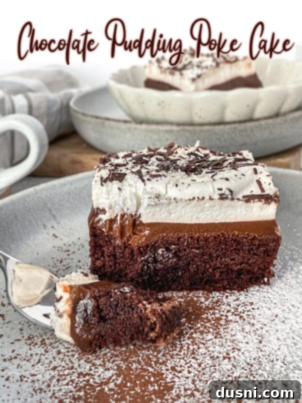Ultimate Chocolate Pudding Dream Cake 19 A beautifully sliced Chocolate Pudding Poke Cake, showing the distinct layers of rich cake, creamy chocolate pudding, and fluffy whipped cream ready for serving.