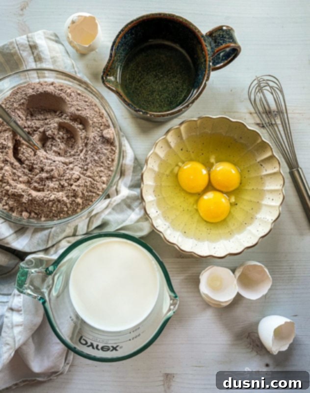 Ultimate Chocolate Pudding Dream Cake 5 Chocolate Pudding Poke Cake with a thick layer of whipped cream, garnished with chocolate shavings.