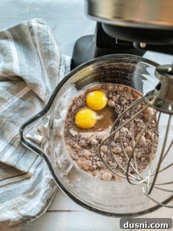 Ultimate Chocolate Pudding Dream Cake 6 Preparing the cake batter in a bowl for the Chocolate Pudding Poke Cake.