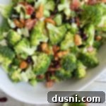 Smoky Cashew Broccoli Crunch 15 Top view of broccoli in bowl with cashews, ready for dressing.