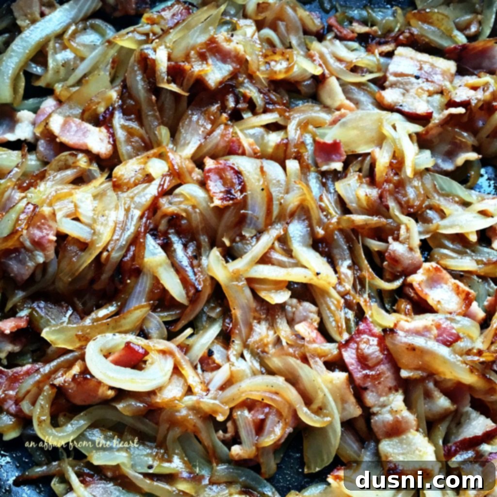 Caramelized onions mixed with cooked bacon pieces, ready for the pie crust filling