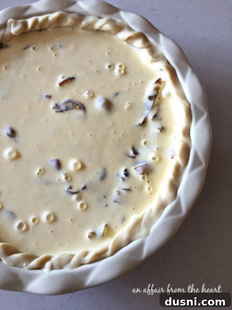 Creamy egg and sour cream mixture poured over the onion and bacon filling in the pie crust