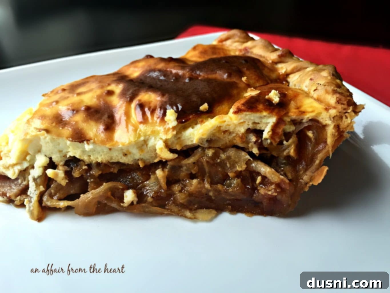 Sliced German Onion Pie (Zwiebelkuchen) showing layers of caramelized onion and bacon