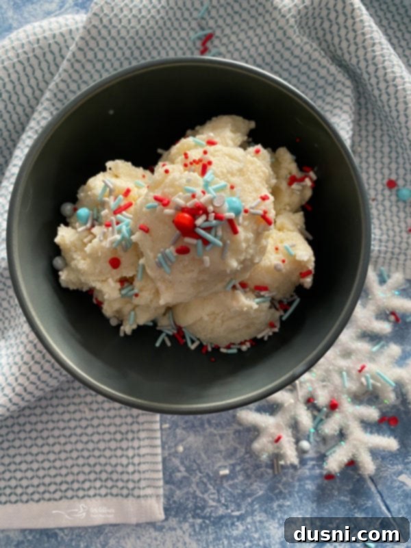 A serving of creamy snow ice cream in a blue bowl, topped with a spoon, highlighting its ready-to-eat texture.
