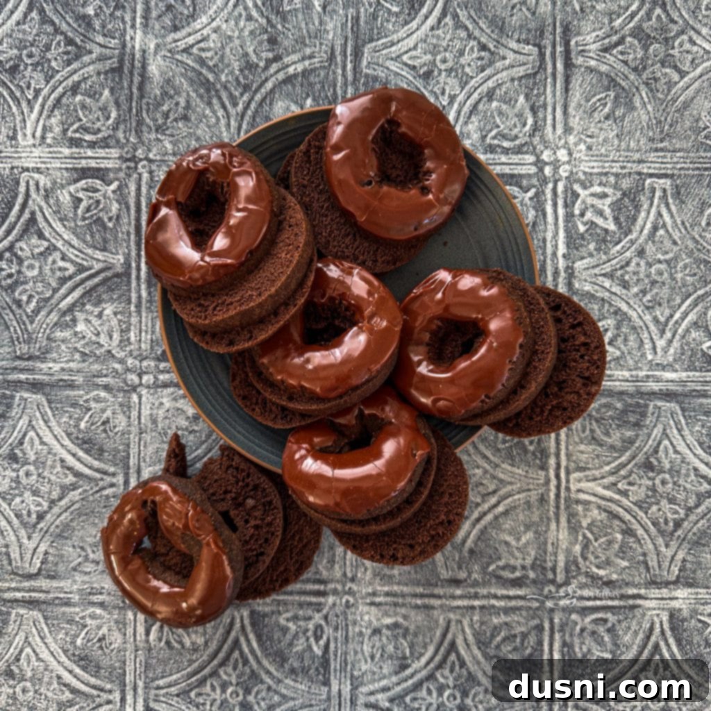 Overhead view of a whole Coffee & Donuts Ice Cream Cake in a loaf pan, decorated with whipped cream.