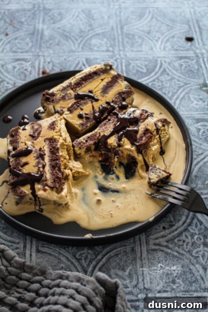 A beautiful slice of Coffee & Donuts Ice Cream Cake on a white plate.