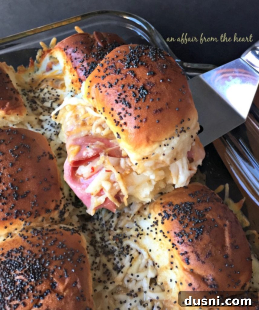 Baked Roast Beef Sliders with Horseradish Sauce, close up, showing the layers of meat and cheese.