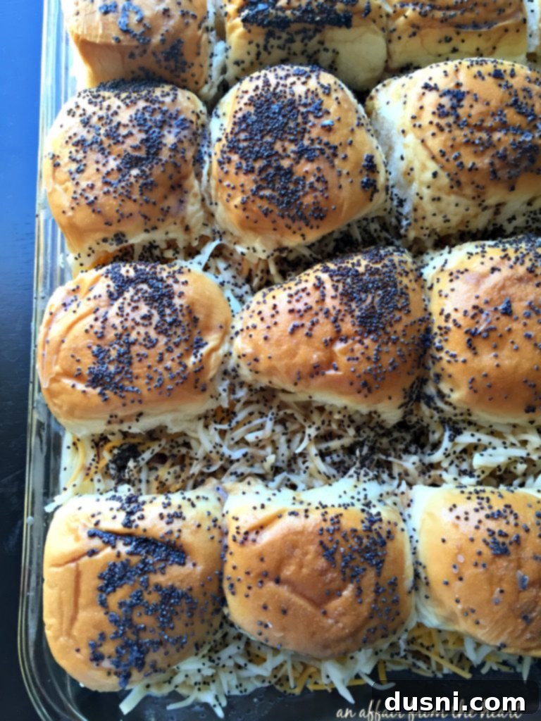 Unbaked Roast Beef Sliders with Horseradish Sauce, showing the rolls assembled in a baking dish.