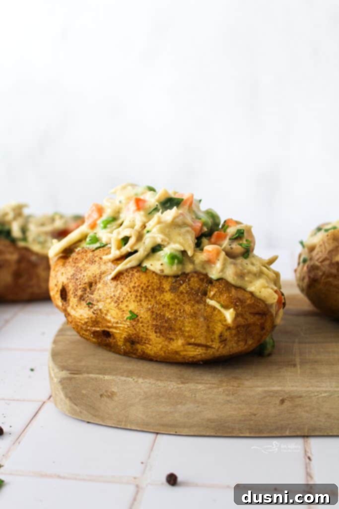 Chicken à la King served in a baked potato with fresh chives.