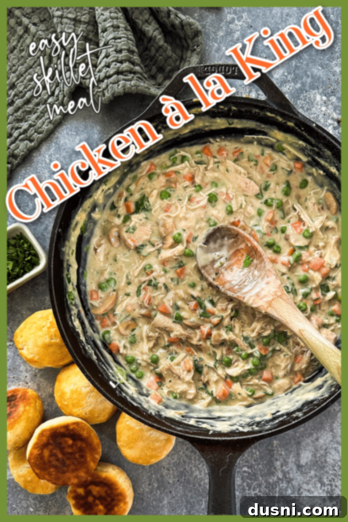 A bowl of Chicken à la King with a spoon, showing its rich texture.