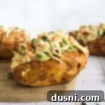 Side view of a Chicken à la King Baked Potato, showing the creamy filling