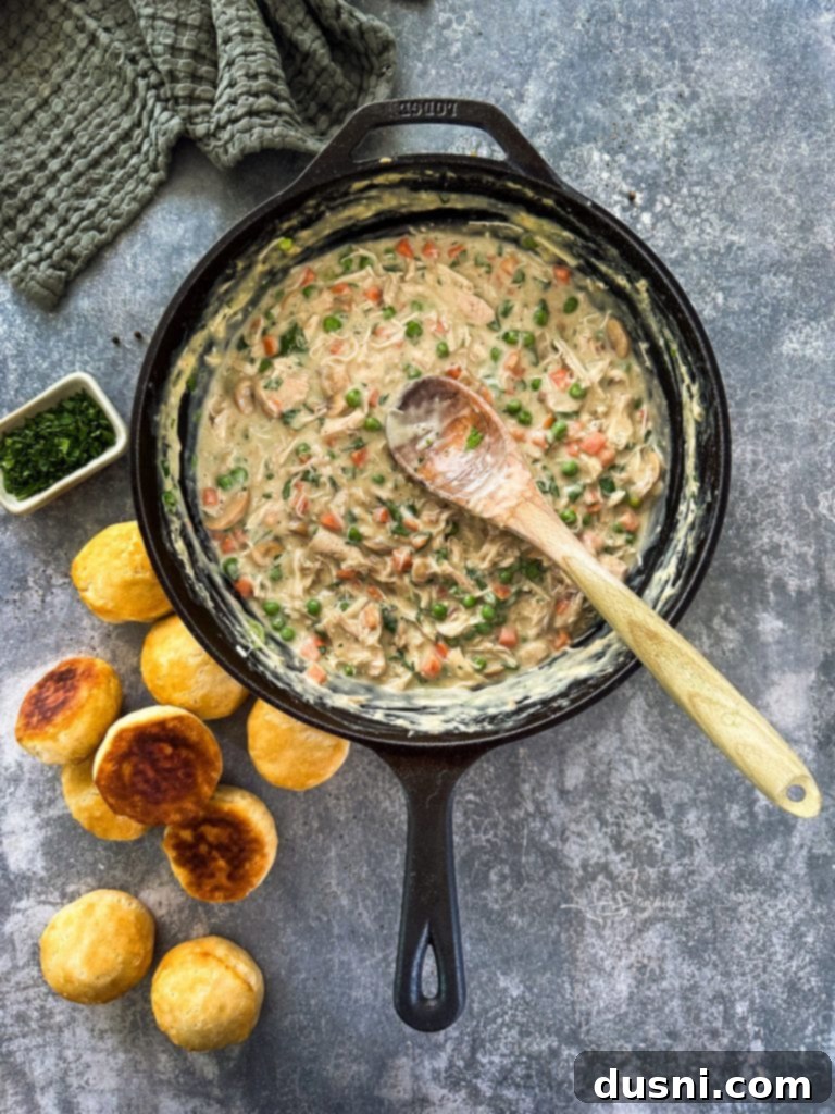 Close-up of creamy Chicken à la King filling with chicken, mushrooms, and peas
