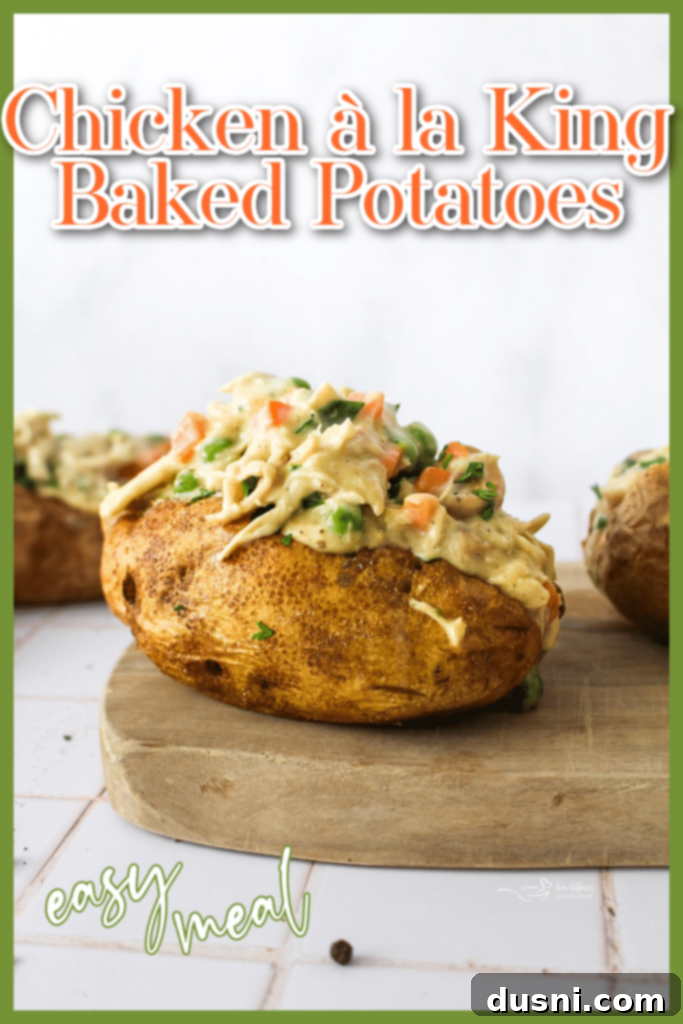 Close-up of a Chicken à la King Baked Potato with a spoon, ready to eat