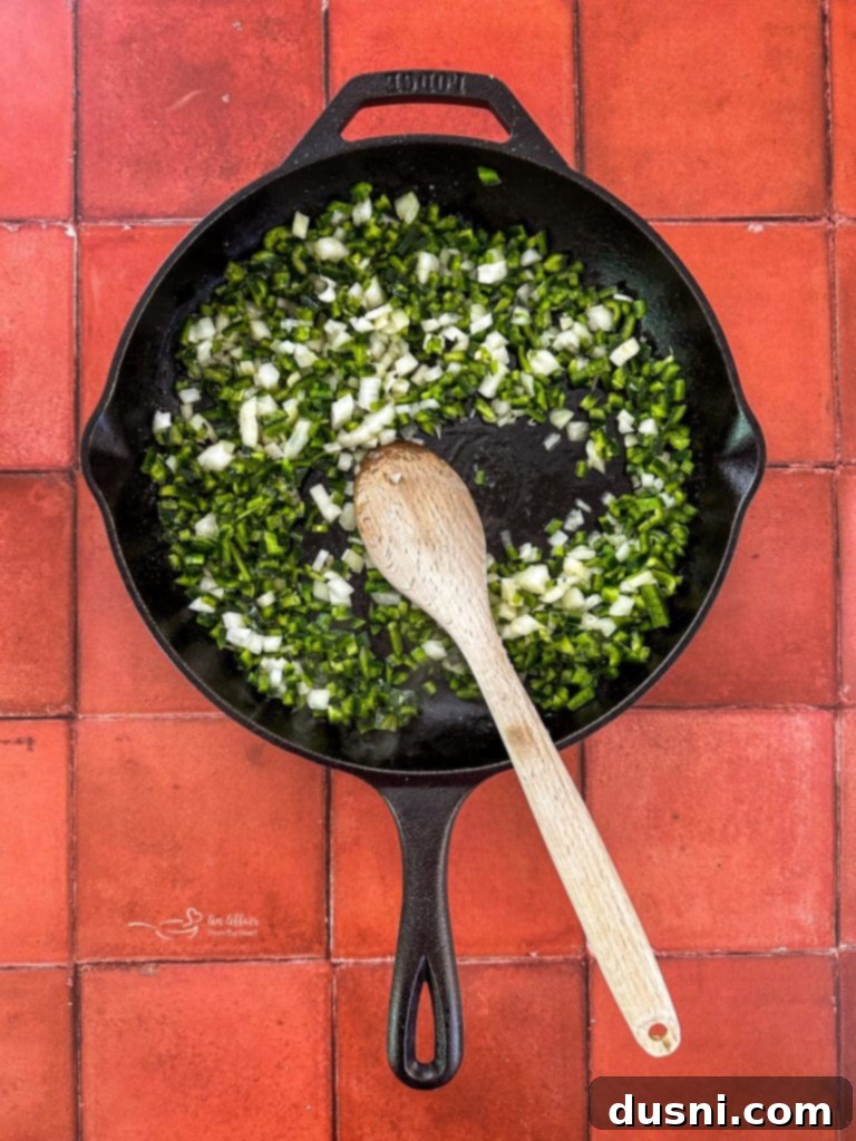 Sautéing poblano peppers and onions in a skillet
