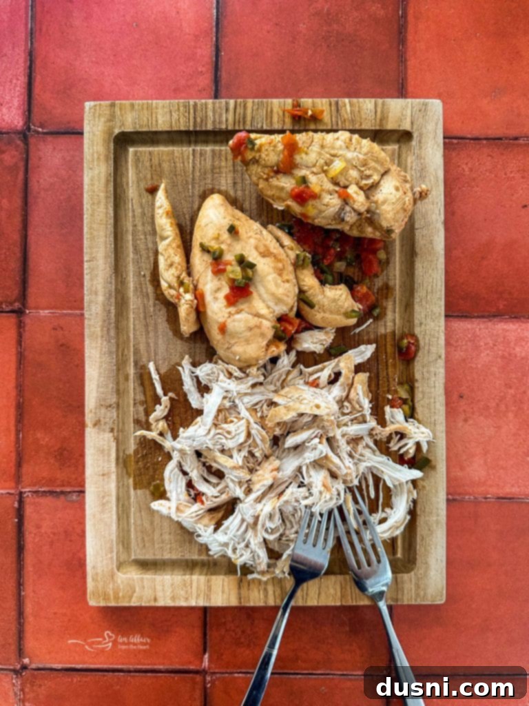 Shredding cooked chicken for the soup