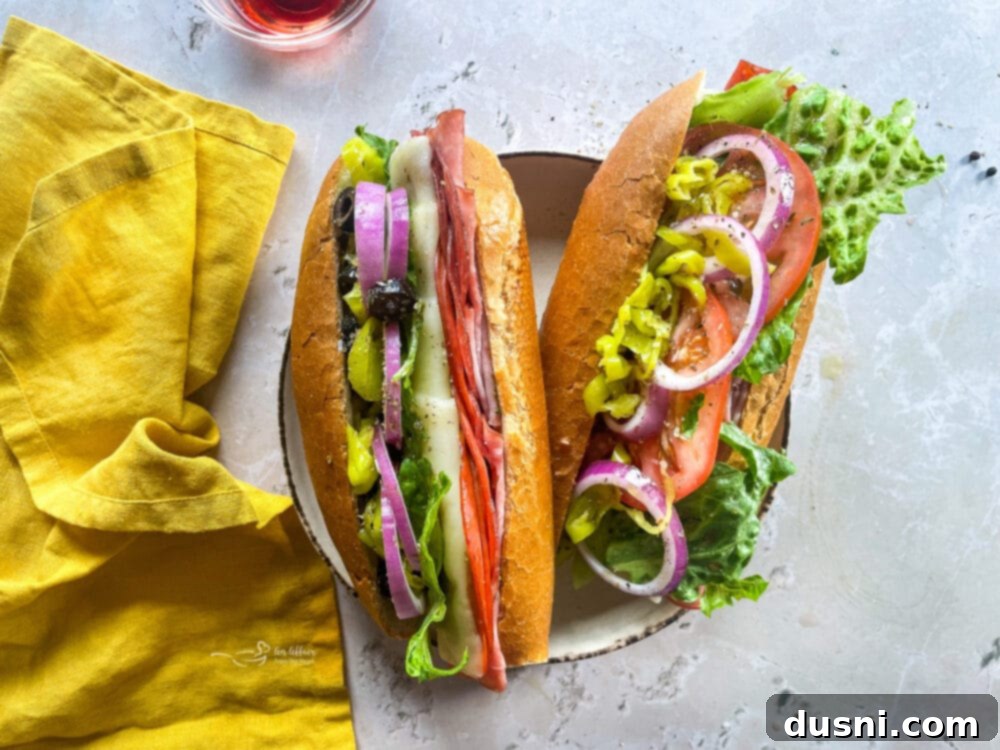 Crispy Italian Sub Melts 11 Two toasted Italian hoagies presented on a white plate