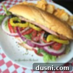 Crispy Italian Sub Melts 19 close up of Toasted Italian Sub Sandwich on a white plate