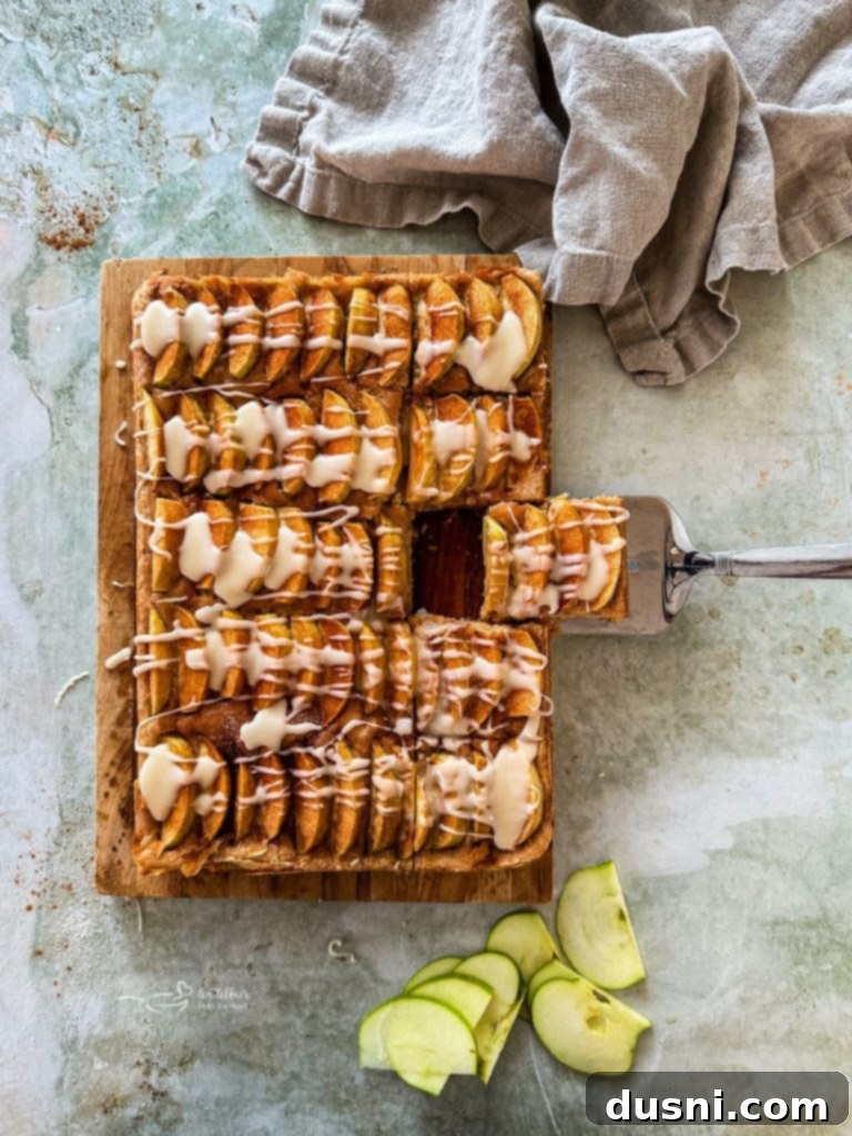 Traditional German Apple Kuchen 2 Freshly baked Apple Kuchen drizzled with vanilla glaze, ready to be served.